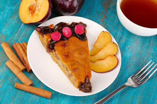 Tasty pie on plate on wooden table — Stock Photo, Image