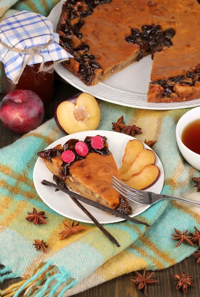 Tasty pie on plate on wooden table — Stock Photo, Image
