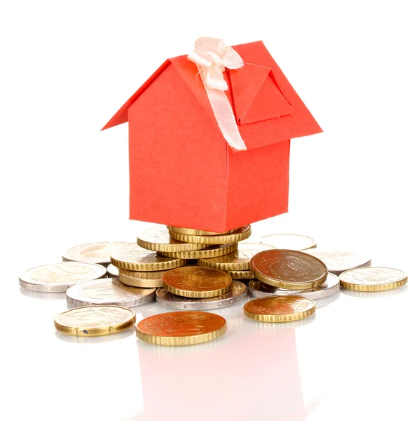 Small house standing on heap of coins — Stock Photo, Image