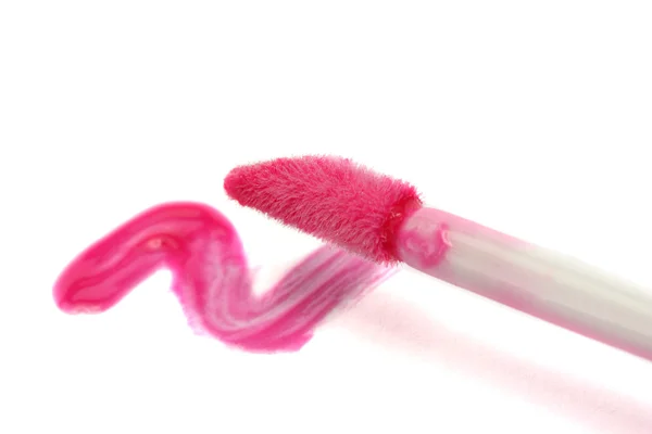 Beautiful lip gloss smear with brush, isolated on white — Stock Photo, Image