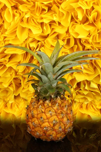 Ripe pineapple on black table on yellow decorative background — Stock Photo, Image