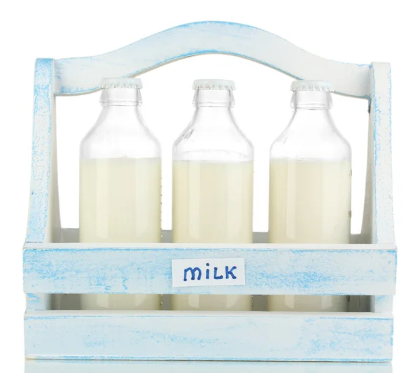 Milk in bottles in wooden box isolated on white — Stock Photo, Image
