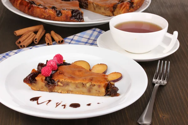 Tasty pie on plate on wooden table — Stock Photo, Image