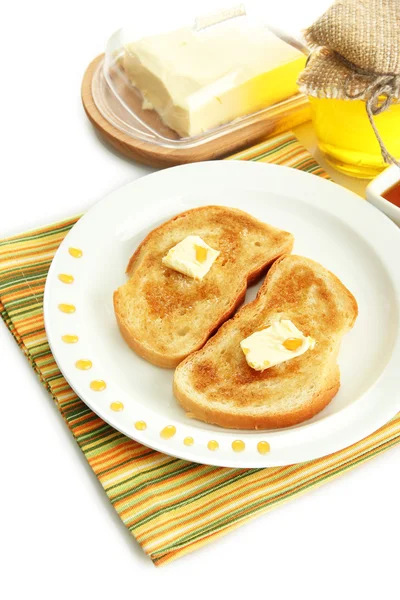 Toast au pain blanc avec du miel dans l'assiette, isolé sur blanc — Photo