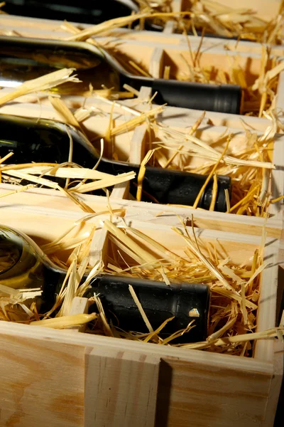 Wooden case with wine bottles close up