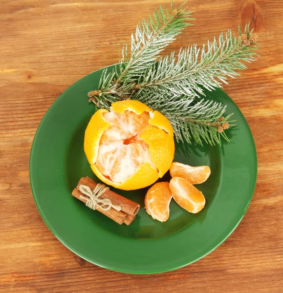 Tasty mandarines color plate on wooden background — Stock Photo, Image