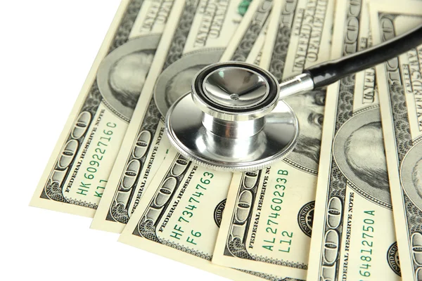 Conceito de custo de cuidados de saúde: estetoscópio e dólares isolados em branco — Fotografia de Stock