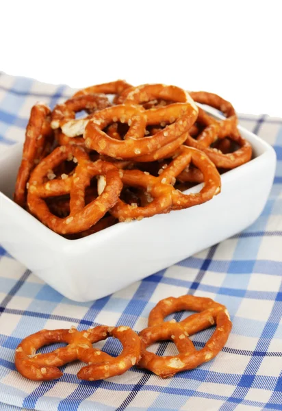 Tasty pretzels in white bowl isolated on white — Stock Photo, Image