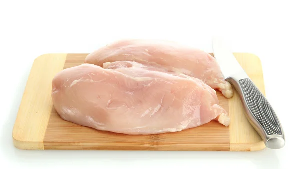 Råt kyllingekød på skærebrættet, isoleret på hvidt - Stock-foto