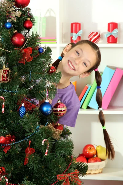Little girl decorating christmas tree Stock Image