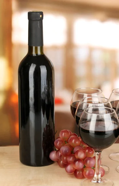 Red wine in glass and bottle on room background — Stock Photo, Image