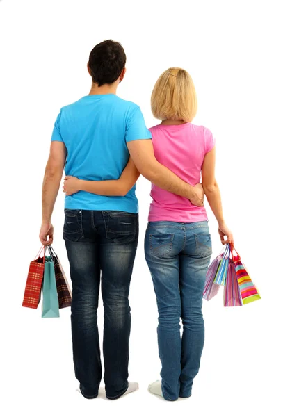 Joven pareja de compras y la celebración de muchas bolsas de compras aisladas en blanco —  Fotos de Stock