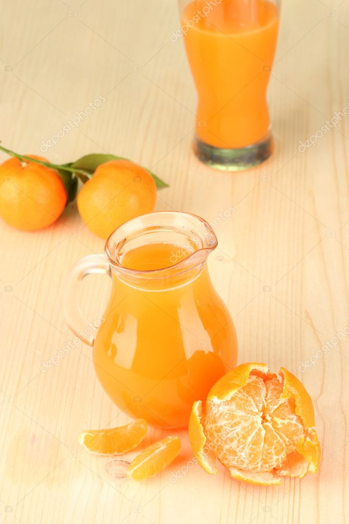 Full jug of tangerine juice, on wooden background — Stock Photo