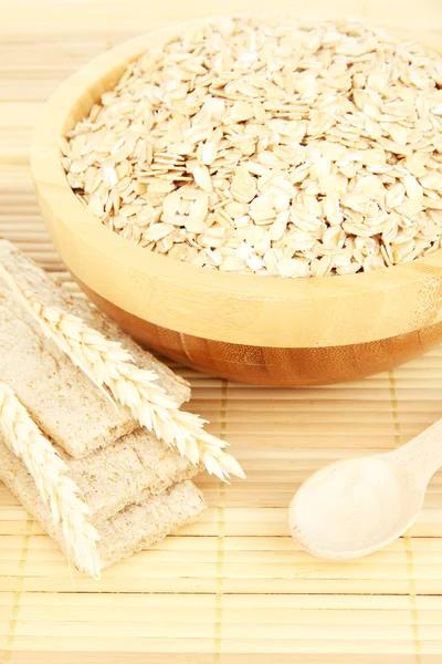 Wooden bowl full of oat flakes — Stock Photo, Image