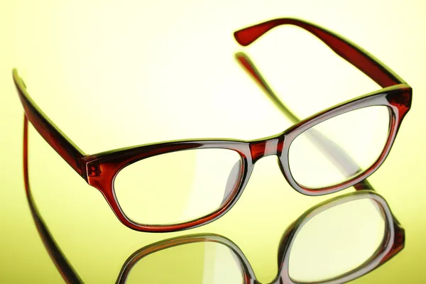 Beautiful glasses on green background — Stock Photo, Image