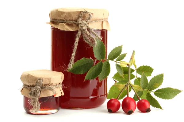 Jars with hip roses jam and ripe berries, isolated on white — Stock Photo, Image