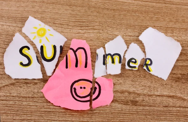 Torn paper with words Summer close-up on wooden table — Stock Photo, Image