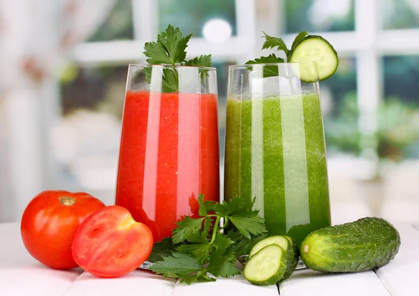 Fresh vegetable juices on wooden table, on window background — Stock Photo, Image