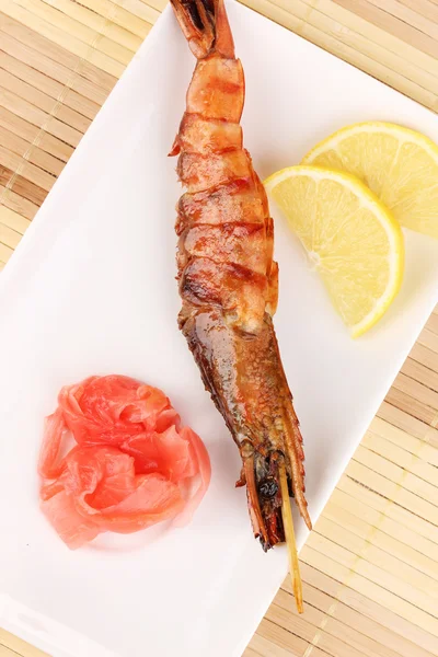 King prawn skewers on plate with ginger and lemon — Stock Photo, Image