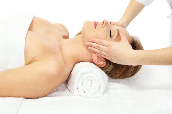 Portrait of beautiful woman taking head massage, isolated on white