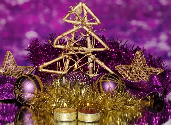 Christmas composition with candles and decorations in purple and gold colors on bright background — Stock Photo, Image