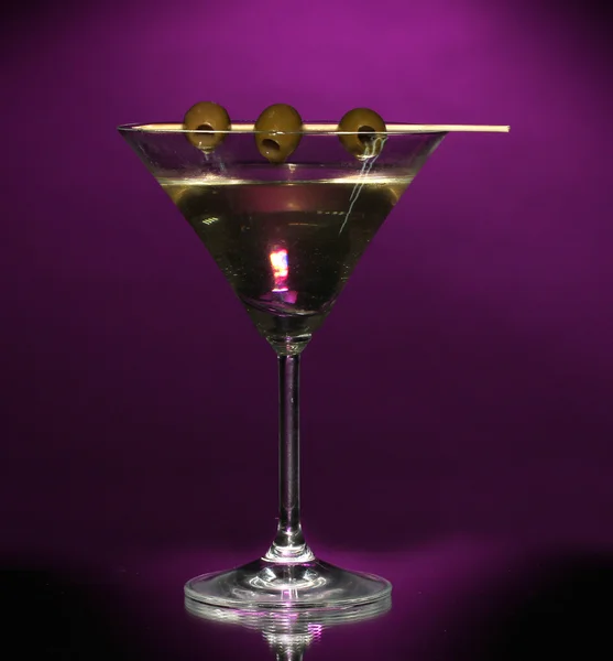 Martini glass and olives on dark background — Stock Photo, Image