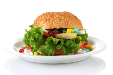 Conceptual image for nutritional care:assorted vitamins and nutritional supplements in bun.Isolated on white clipart