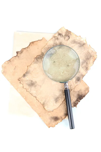 Old paper with magnifying glass isolated on white — Stock Photo, Image