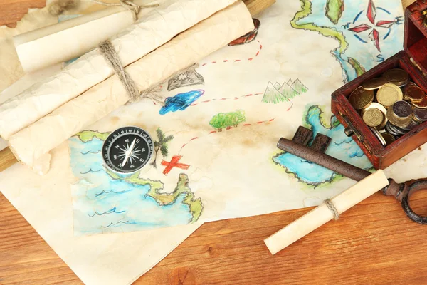 Map of treasures on wooden background — Stock Photo, Image