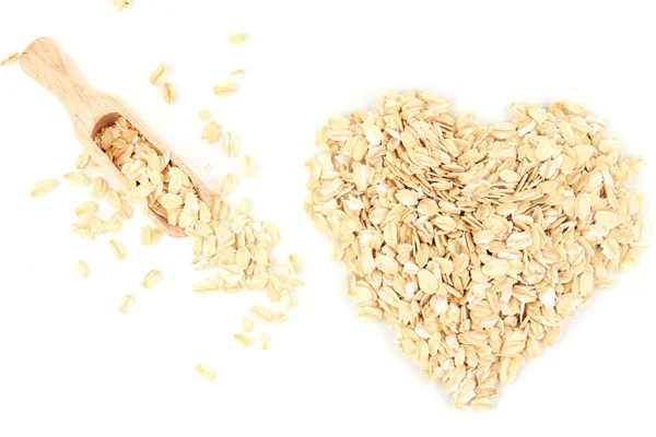 Forma de corazón hecha de copos de avena con cuchara de madera aislada en blanco — Foto de Stock