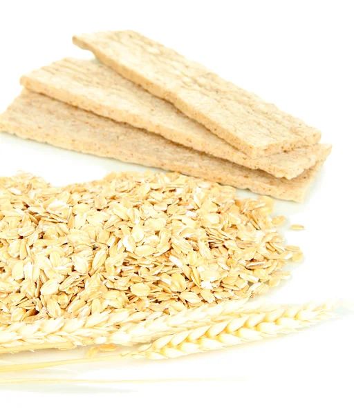 Oat flakes pile with spikelets and oat biscuits isolated on white — Stock Photo, Image
