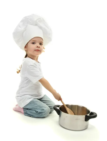 Niña doctora en sombrero de chef con sartén y cuchara, aislada en blanco — Foto de Stock