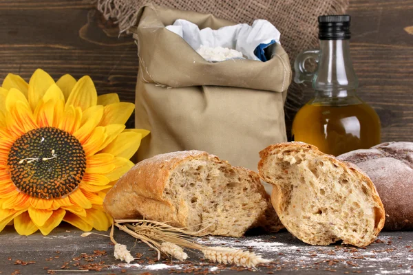 Rye bread on wooden table on wooden background — Stock Photo, Image