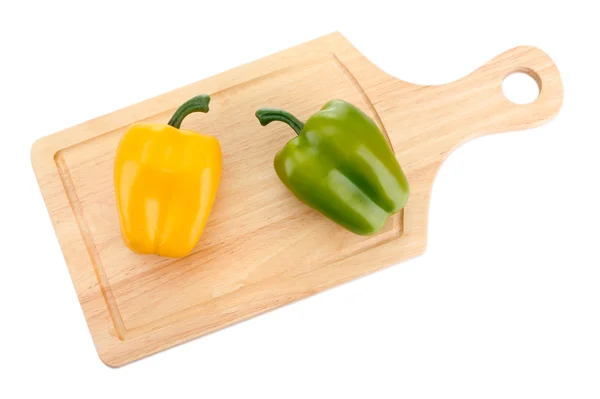 Paprika on wooden cutting board isolated on white — Stock Photo, Image