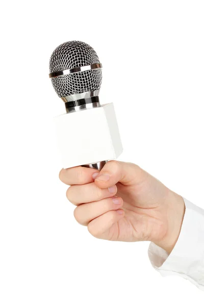 Mano femminile con microfono isolato su bianco — Foto Stock