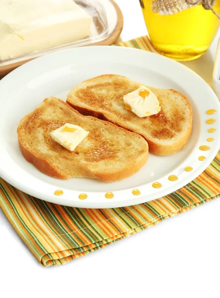 Pan blanco tostado con miel en plato, aislado sobre blanco — Foto de Stock