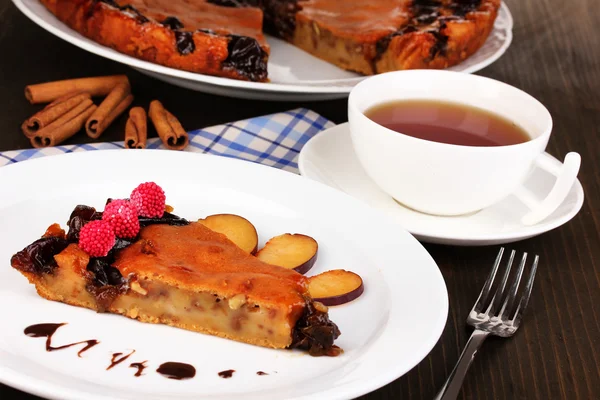 Tasty pie on plate on wooden table — Stock Photo, Image