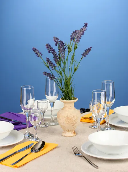 Table setting in violet and yellow tones on color background — Stock Photo, Image