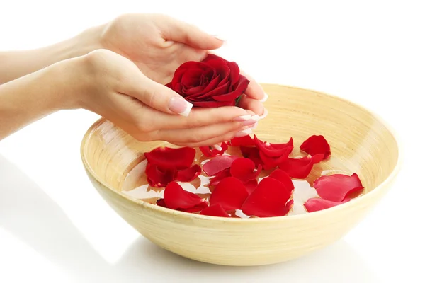 Woman hands with wooden bowl of water with petals, isolated on white — Stock Photo, Image