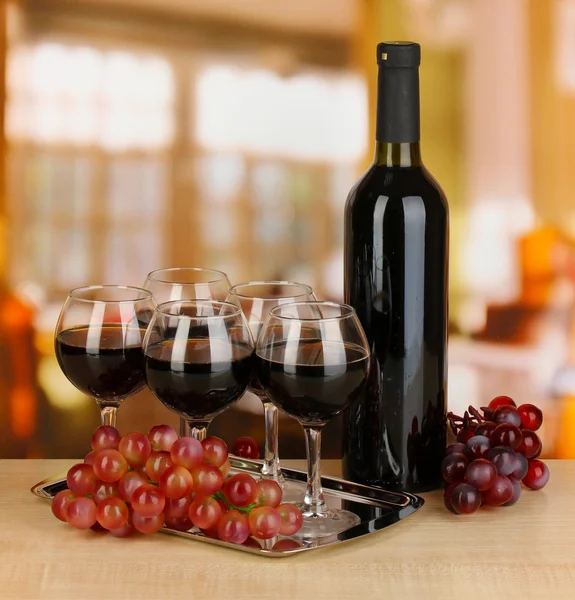 Red wine in glass and bottle on room background — Stock Photo, Image