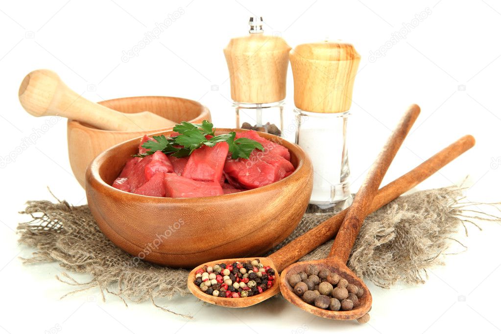 Raw beef meat in bowl with herbs and spices isolated on white
