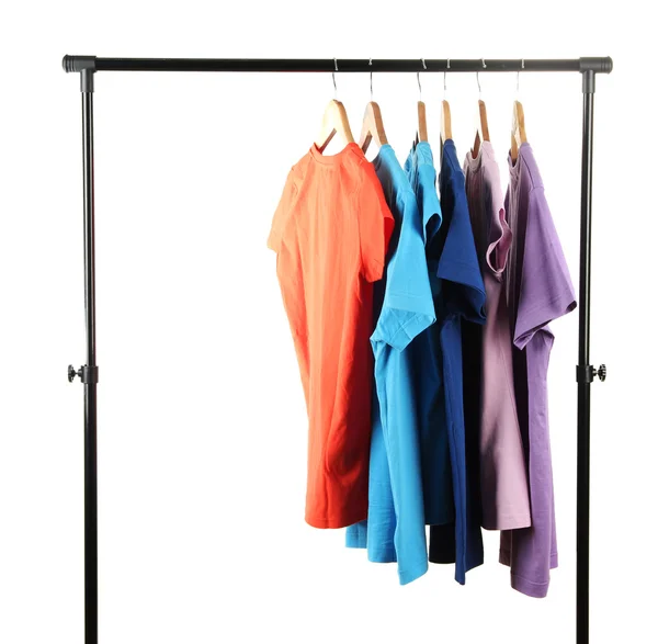 Choice of clothes of different colors on wooden hangers, isolated on white — Stock Photo, Image