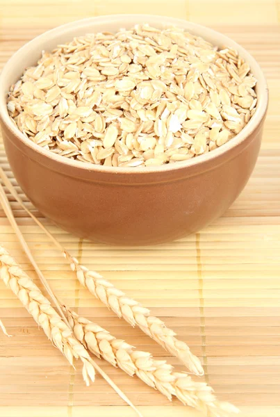 Brown bowl full of oat flakes — Stock Photo, Image