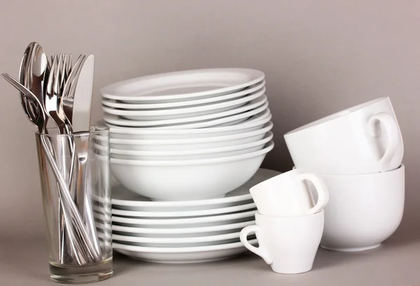 Clean white dishes on grey background — Stock Photo, Image