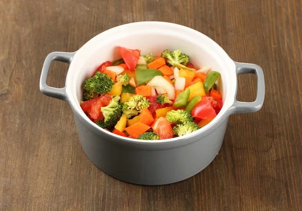 Vegetable stew in gray pot on wooden background — Stock Photo, Image