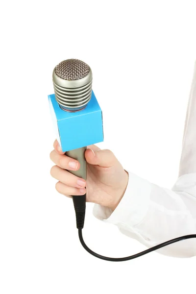 Main féminine avec microphone isolé sur blanc — Photo