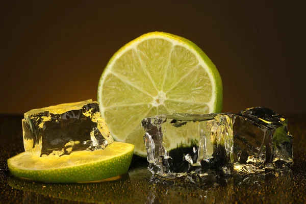 Kostki lodu z limonki na tle darck pomarańczowy — Zdjęcie stockowe
