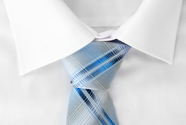New white man's shirt with color tie on wooden background