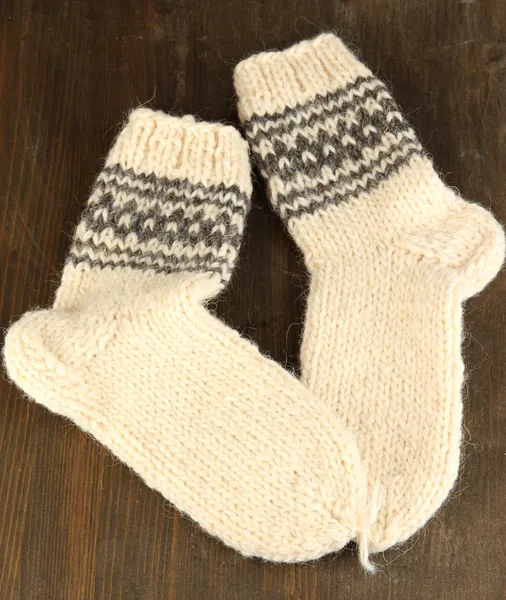 Teplé pletené ponožky na dřevěný stůl detail — Stock fotografie