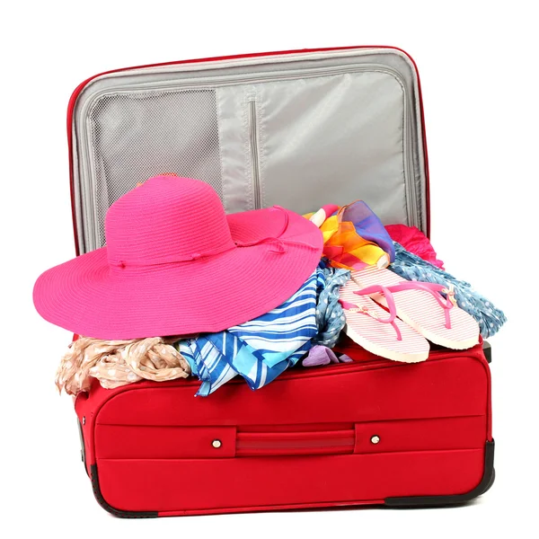 Suitcase with summer clothes, a hat and suntan isolated on white — Stok fotoğraf